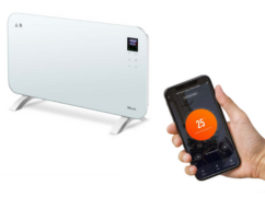 A white TCP smart glass panel radiator with a mobile app used to control it