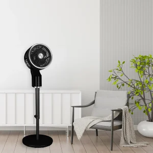 A TCP black pedestal 3d oscillation standing fan beside a grey chair